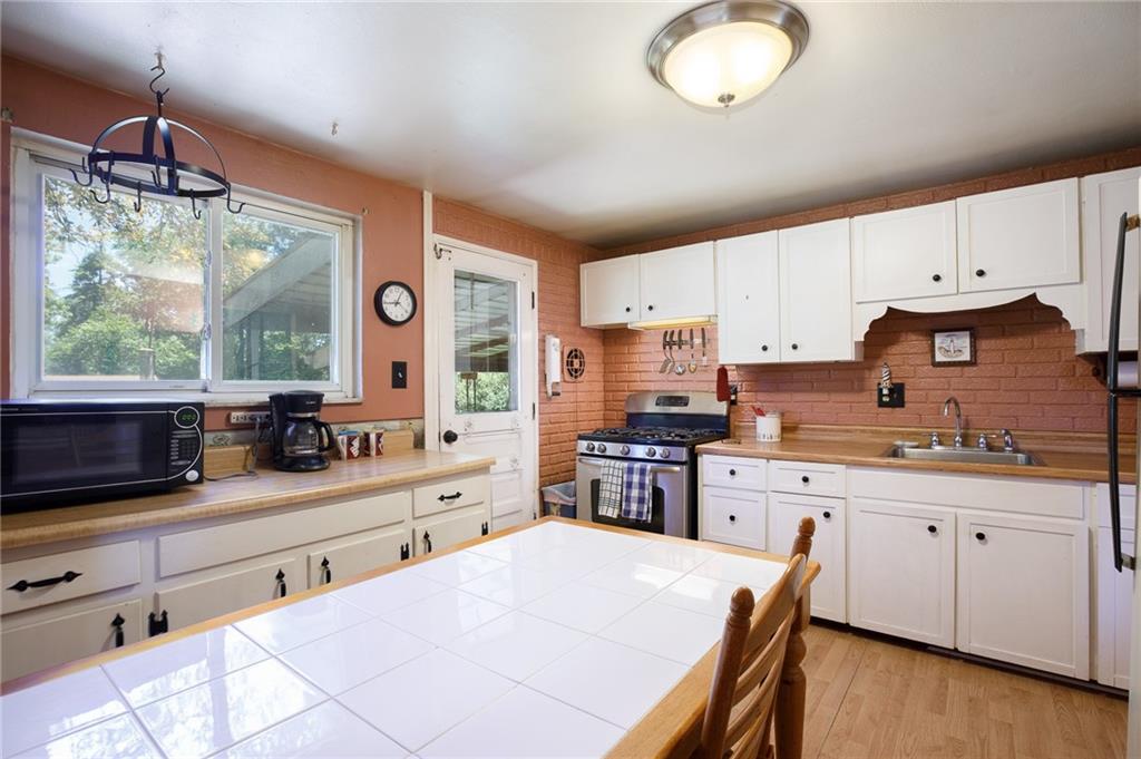 528 MacBeth Drive Pittsburgh, PA 15235 - Photo 7 of 20 a kitchen with stainless steel appliances a stove a sink a center island and cabinets