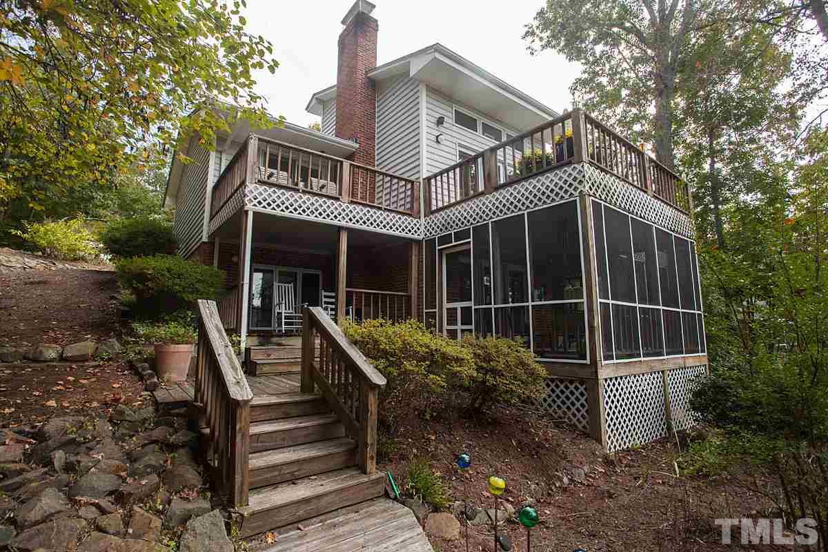 11 Hidden Hills Road Roxboro, NC 27574 - Photo 1 of 25 a front view of a house with plants and wooden fence