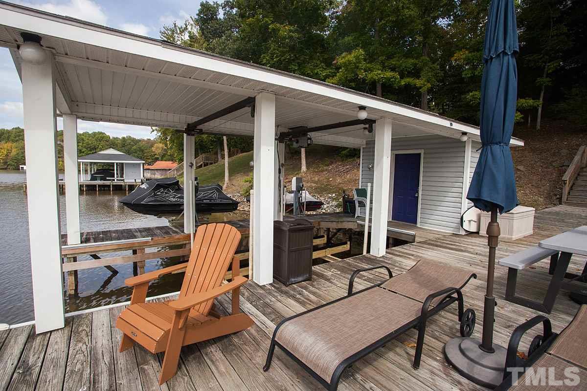 11 Hidden Hills Road Roxboro, NC 27574 - Photo 5 of 25 a view of a patio with a dining table and chairs with wooden floor