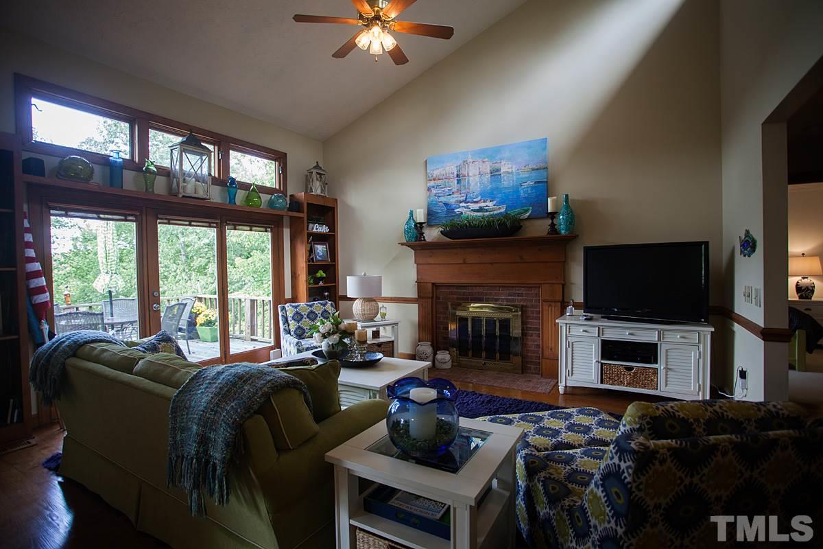 11 Hidden Hills Road Roxboro, NC 27574 - Photo 6 of 25 a living room with furniture a fireplace and a flat screen tv