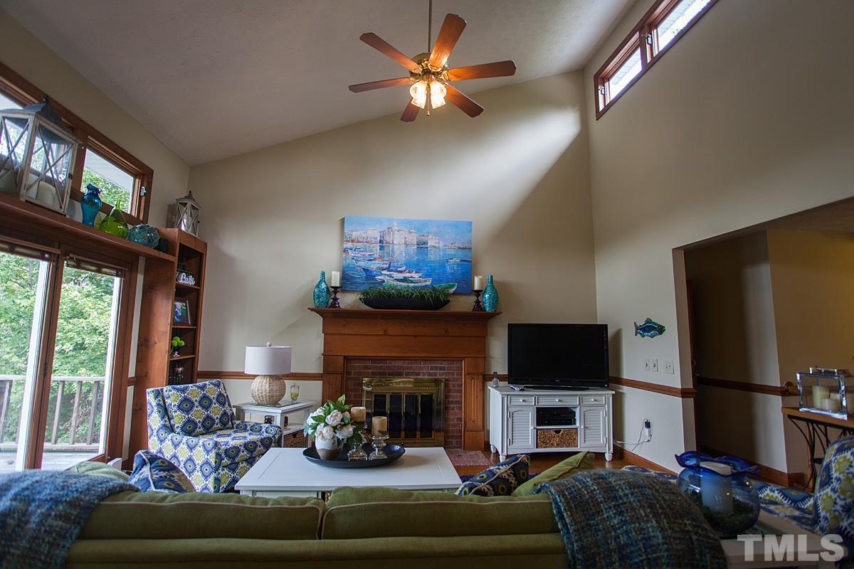 11 Hidden Hills Road Roxboro, NC 27574 - Photo 7 of 25 a living room with furniture a flat screen tv and a fireplace
