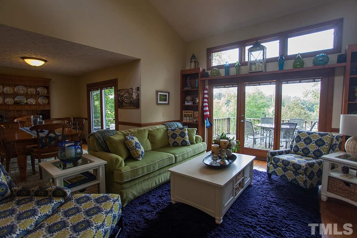 11 Hidden Hills Road Roxboro, NC 27574 - Photo 8 of 25 a living room with furniture and large windows