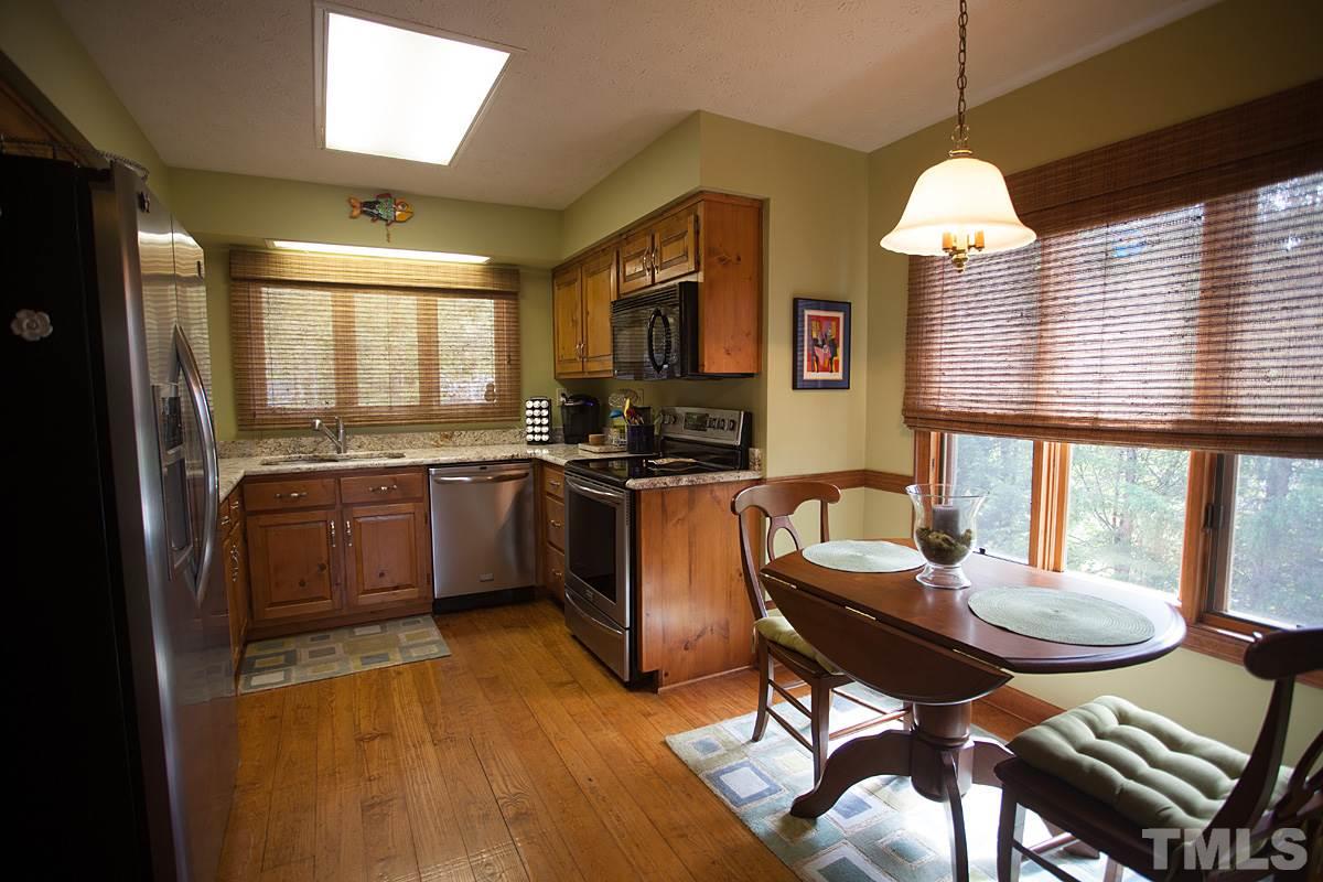 11 Hidden Hills Road Roxboro, NC 27574 - Photo 10 of 25 a kitchen with stainless steel appliances granite countertop a stove a sink and a refrigerator