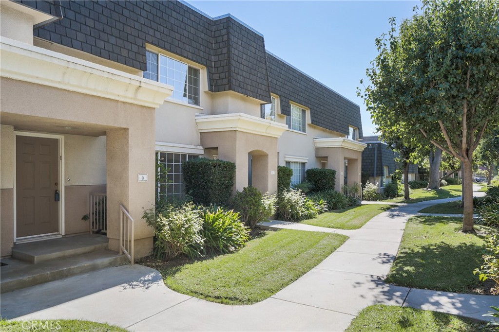 19234 Hamlin Street, Unit 5 Reseda, CA 91335 - Photo 1 of 1 front view of a house with a yard