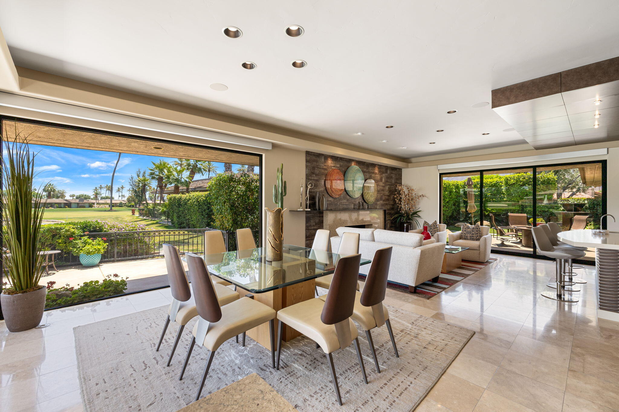 4 Barnard Court Rancho Mirage, CA 92270 - Photo 11 of 62 a dining room with furniture large windows and wooden floor