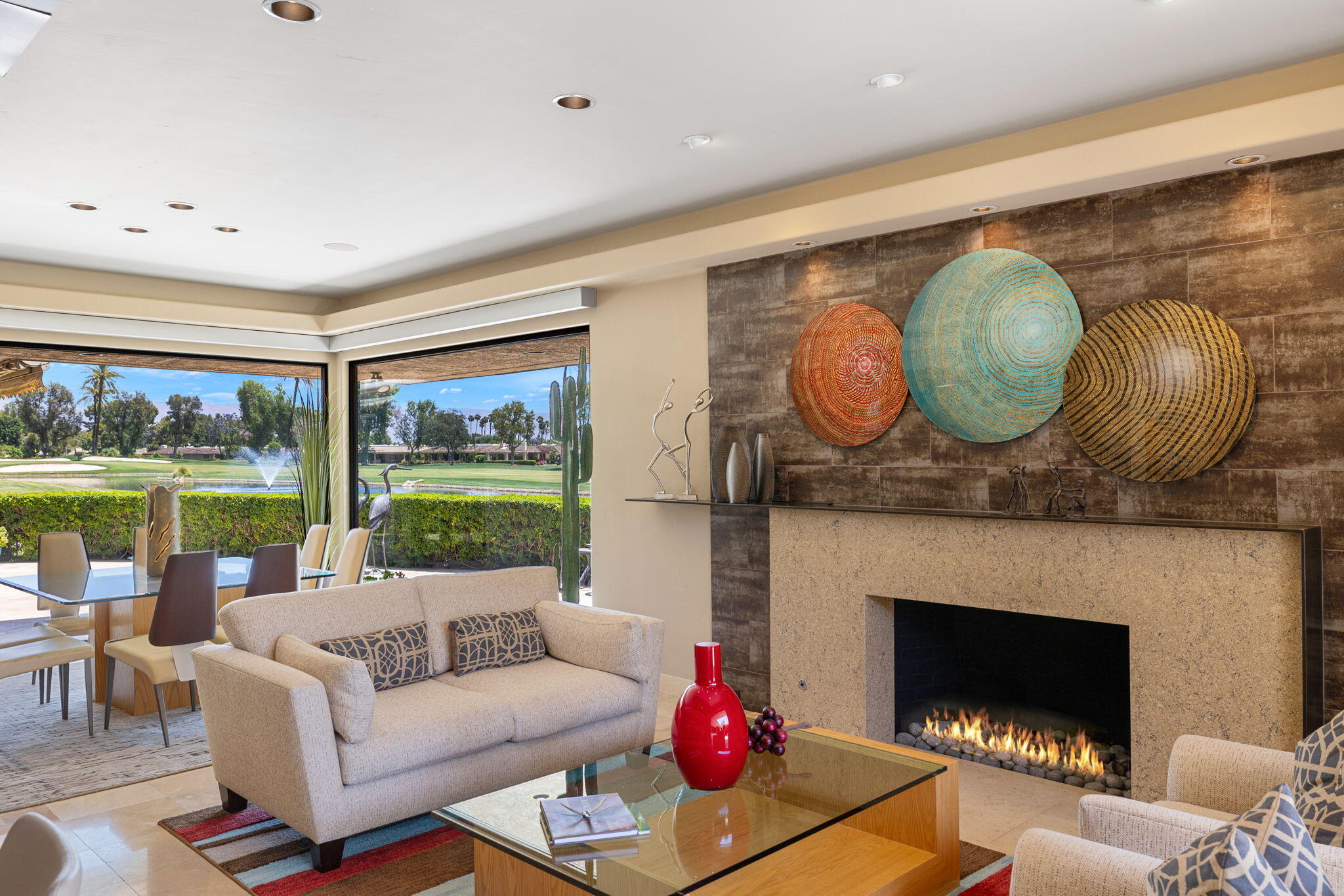 4 Barnard Court Rancho Mirage, CA 92270 - Photo 13 of 62 a living room with furniture a floor to ceiling window and a fireplace
