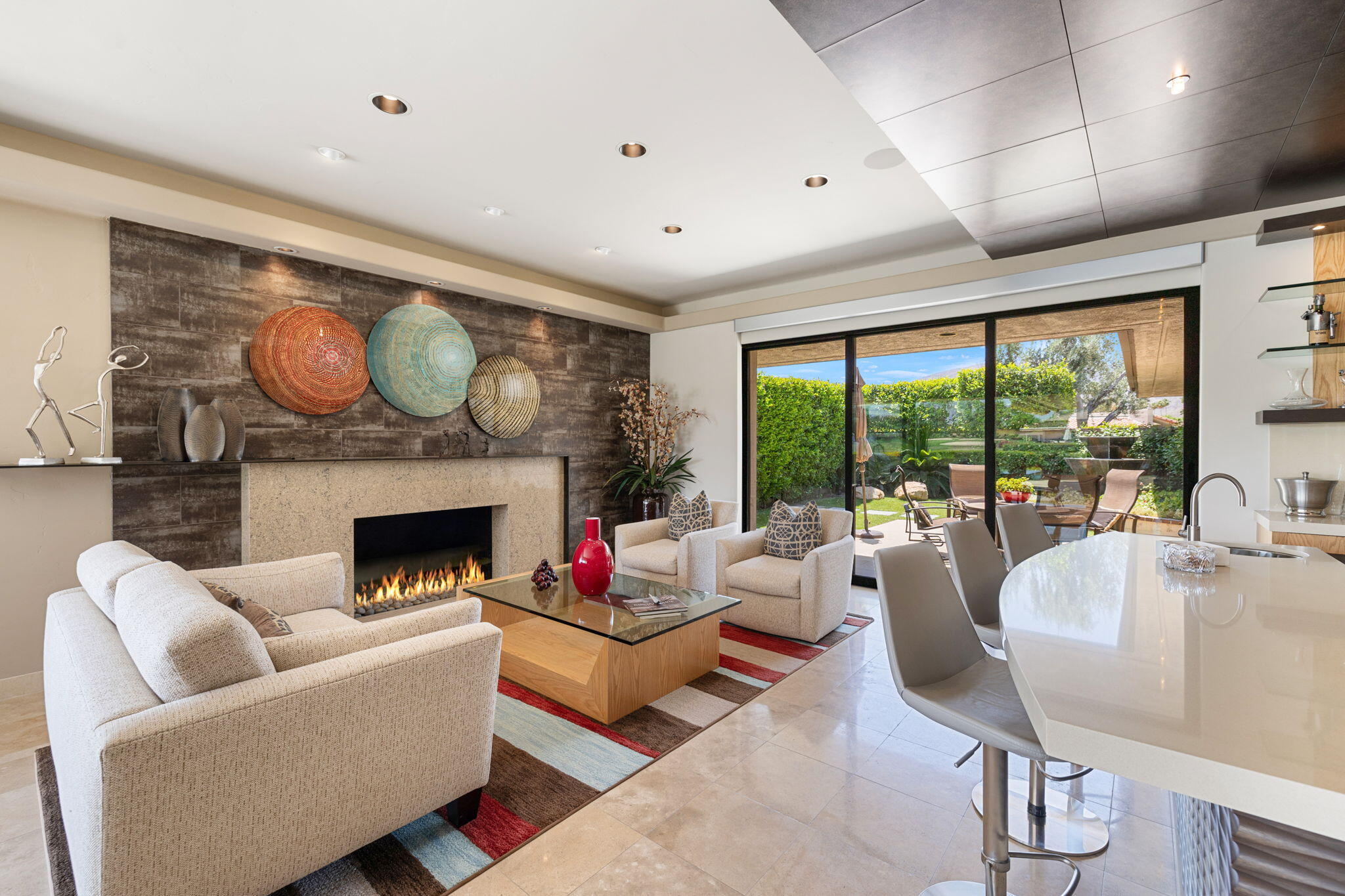 4 Barnard Court Rancho Mirage, CA 92270 - Photo 19 of 62 a living room with furniture a fireplace and floor to ceiling windows