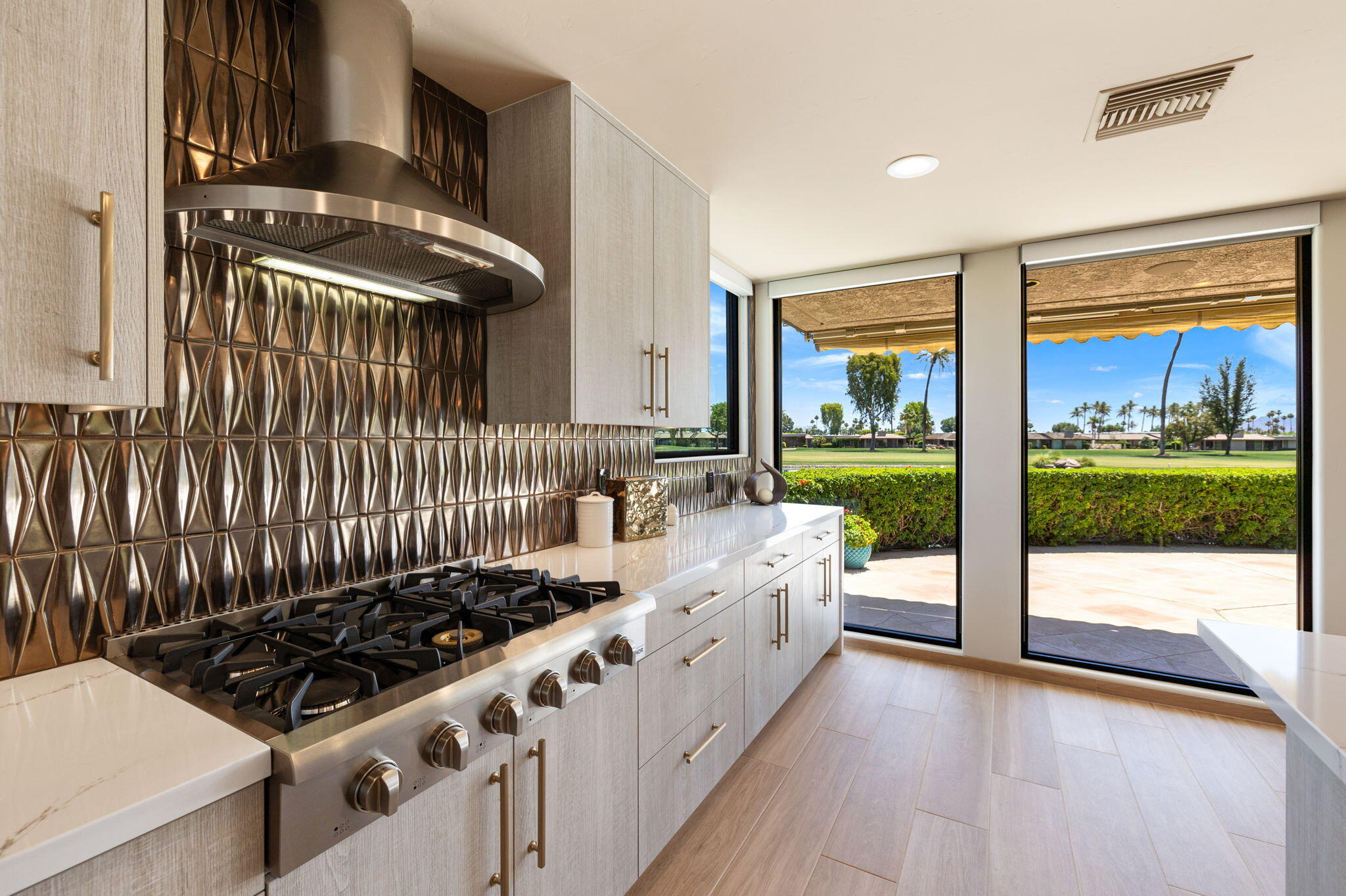 4 Barnard Court Rancho Mirage, CA 92270 - Photo 25 of 62 a kitchen with stove and cabinets