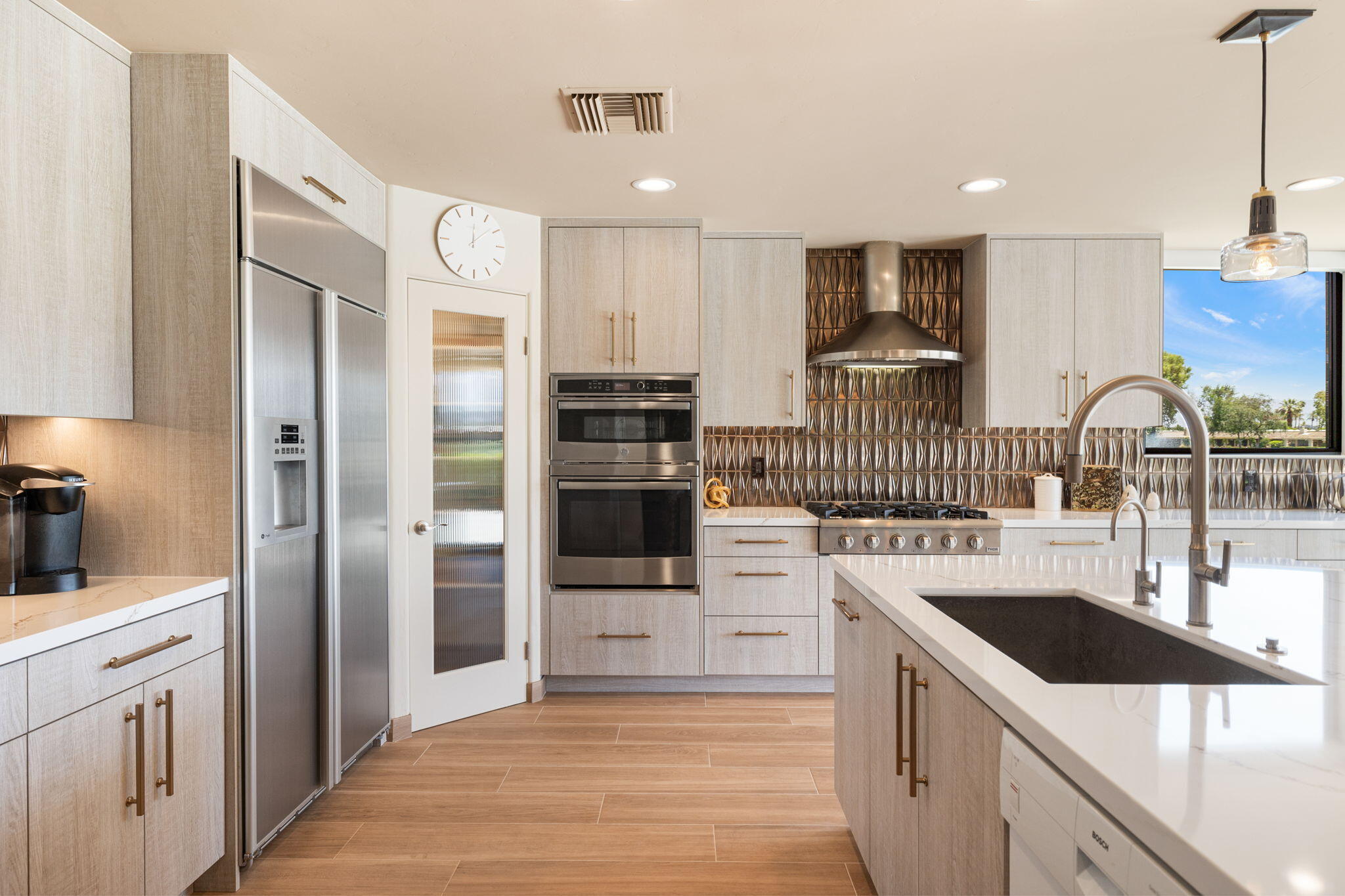 4 Barnard Court Rancho Mirage, CA 92270 - Photo 26 of 62 a kitchen with stainless steel appliances kitchen island granite countertop a refrigerator and a sink