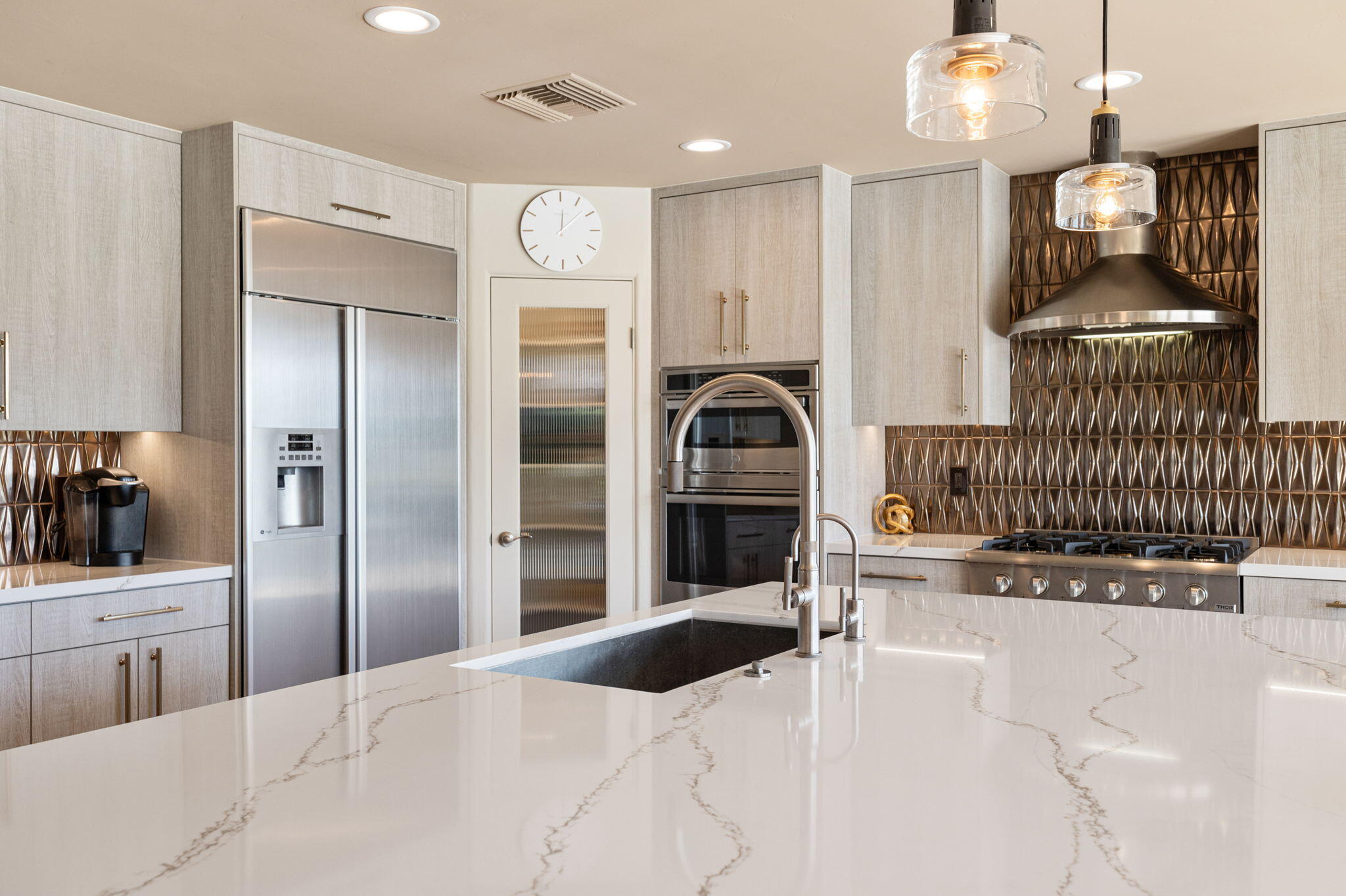 4 Barnard Court Rancho Mirage, CA 92270 - Photo 27 of 62 a kitchen with stainless steel appliances kitchen island granite countertop a refrigerator and a stove top oven