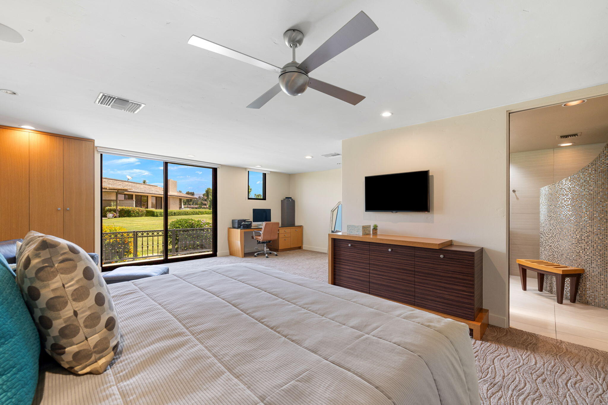 4 Barnard Court Rancho Mirage, CA 92270 - Photo 36 of 62 a spacious bedroom with a bed flat screen tv and a large window