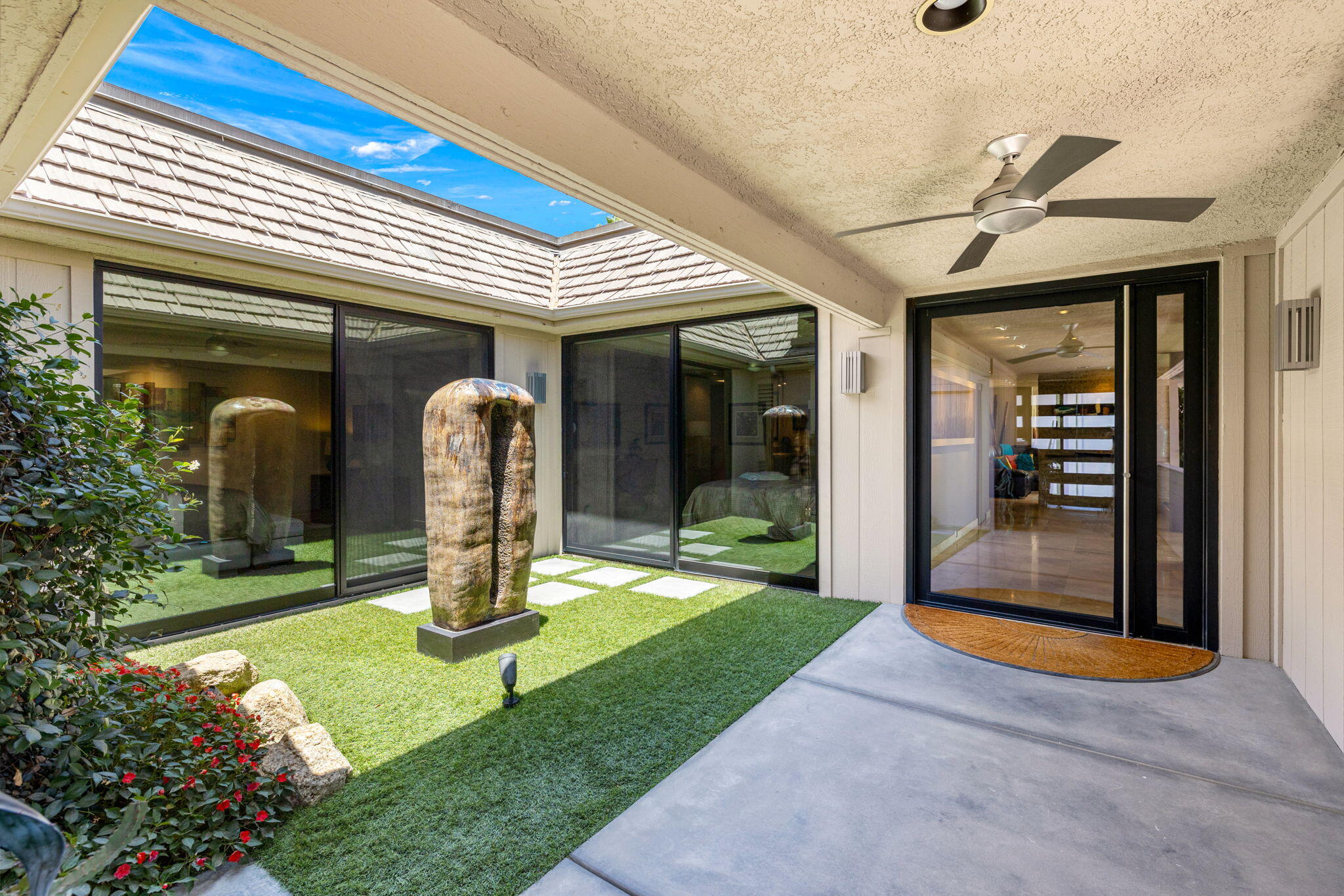 4 Barnard Court Rancho Mirage, CA 92270 - Photo 4 of 62 a view of a building with a porch and potted plants