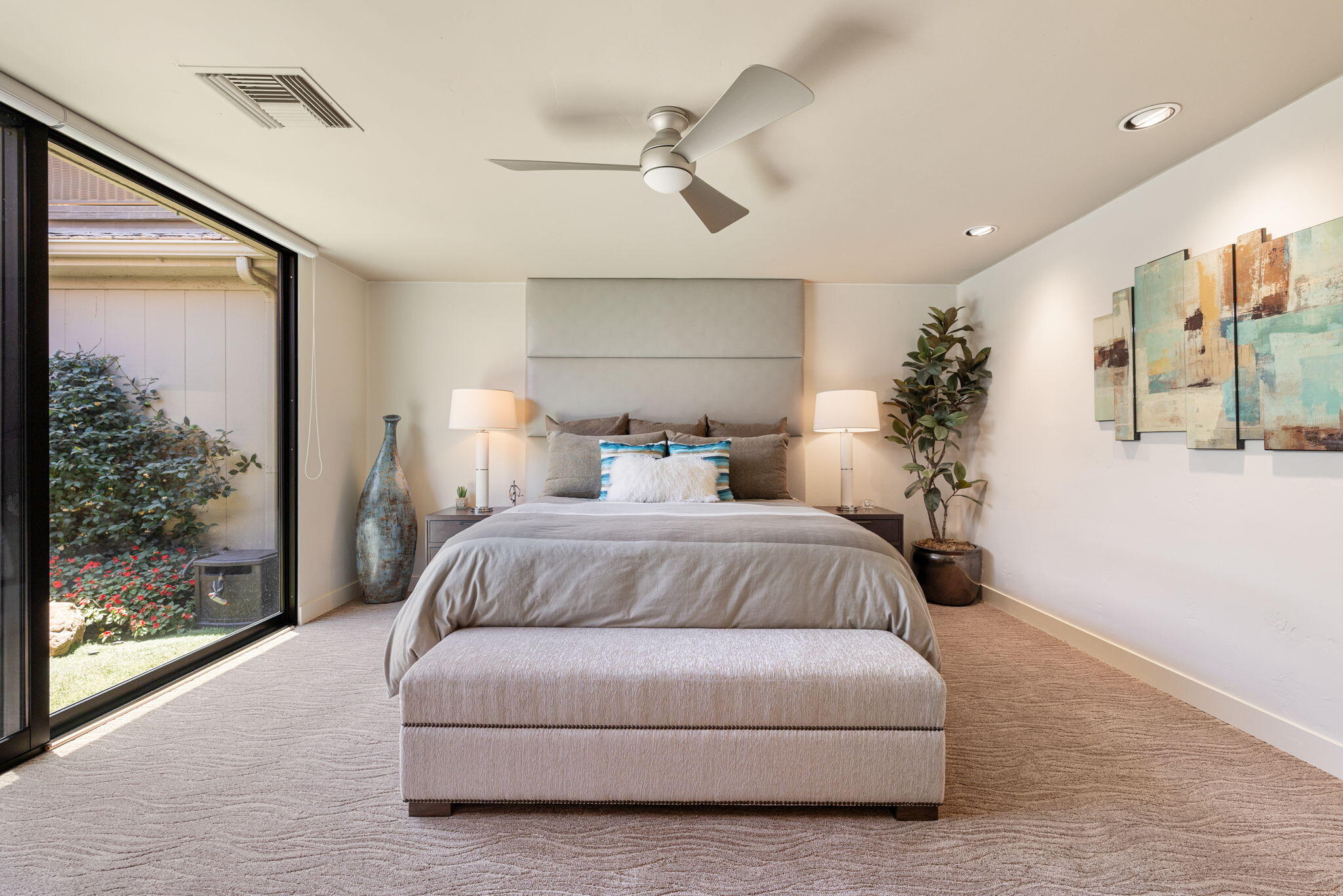 4 Barnard Court Rancho Mirage, CA 92270 - Photo 42 of 62 a bedroom with a large bed and a chandelier fan