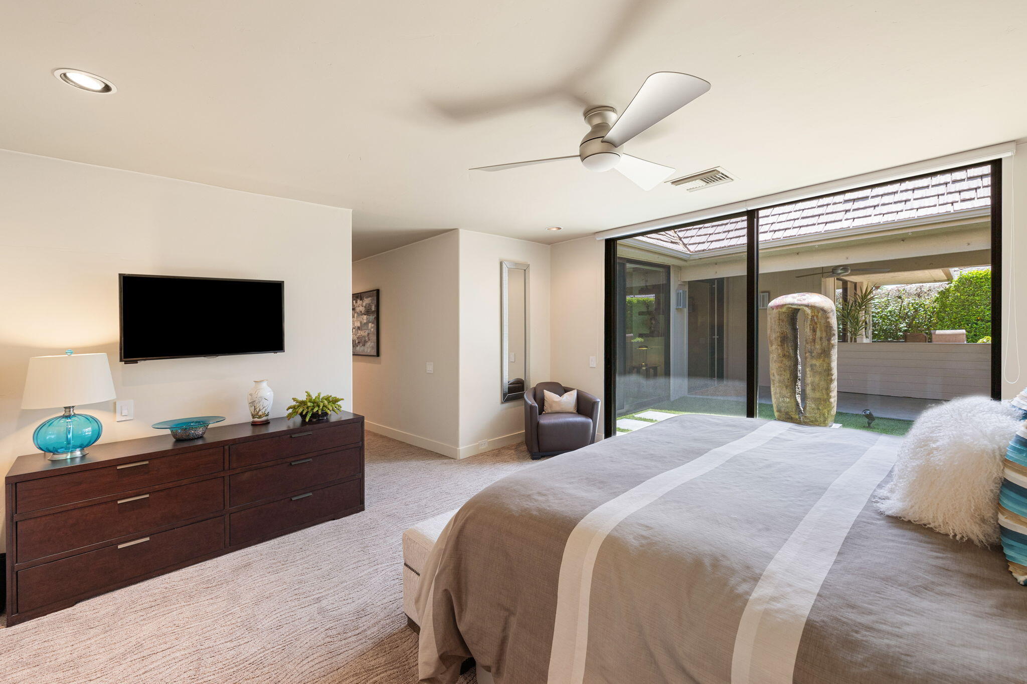 4 Barnard Court Rancho Mirage, CA 92270 - Photo 43 of 62 a bedroom with a bed and a flat tv screen on dresser