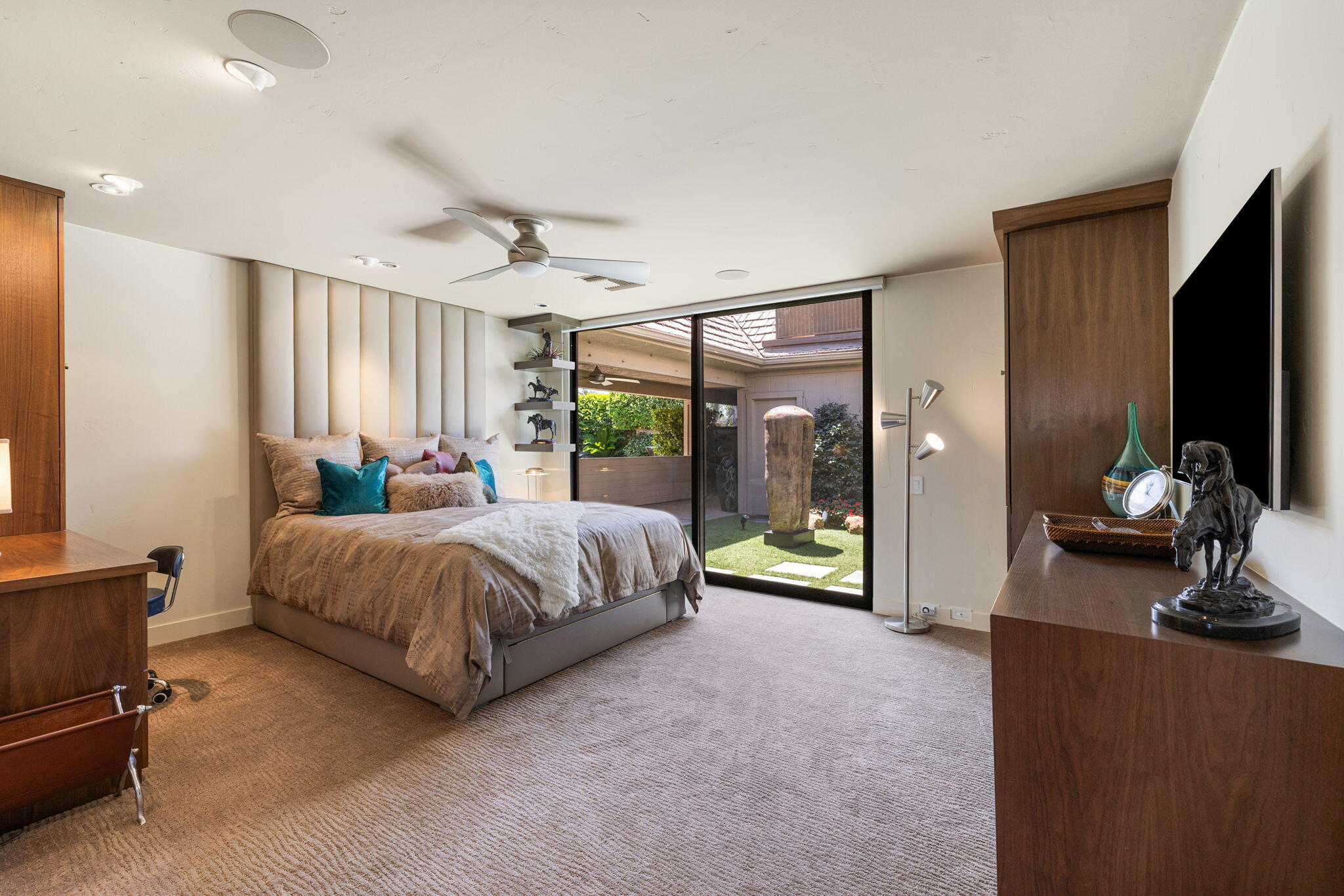 4 Barnard Court Rancho Mirage, CA 92270 - Photo 46 of 62 a spacious bedroom with a bed and a flat tv screen on wall