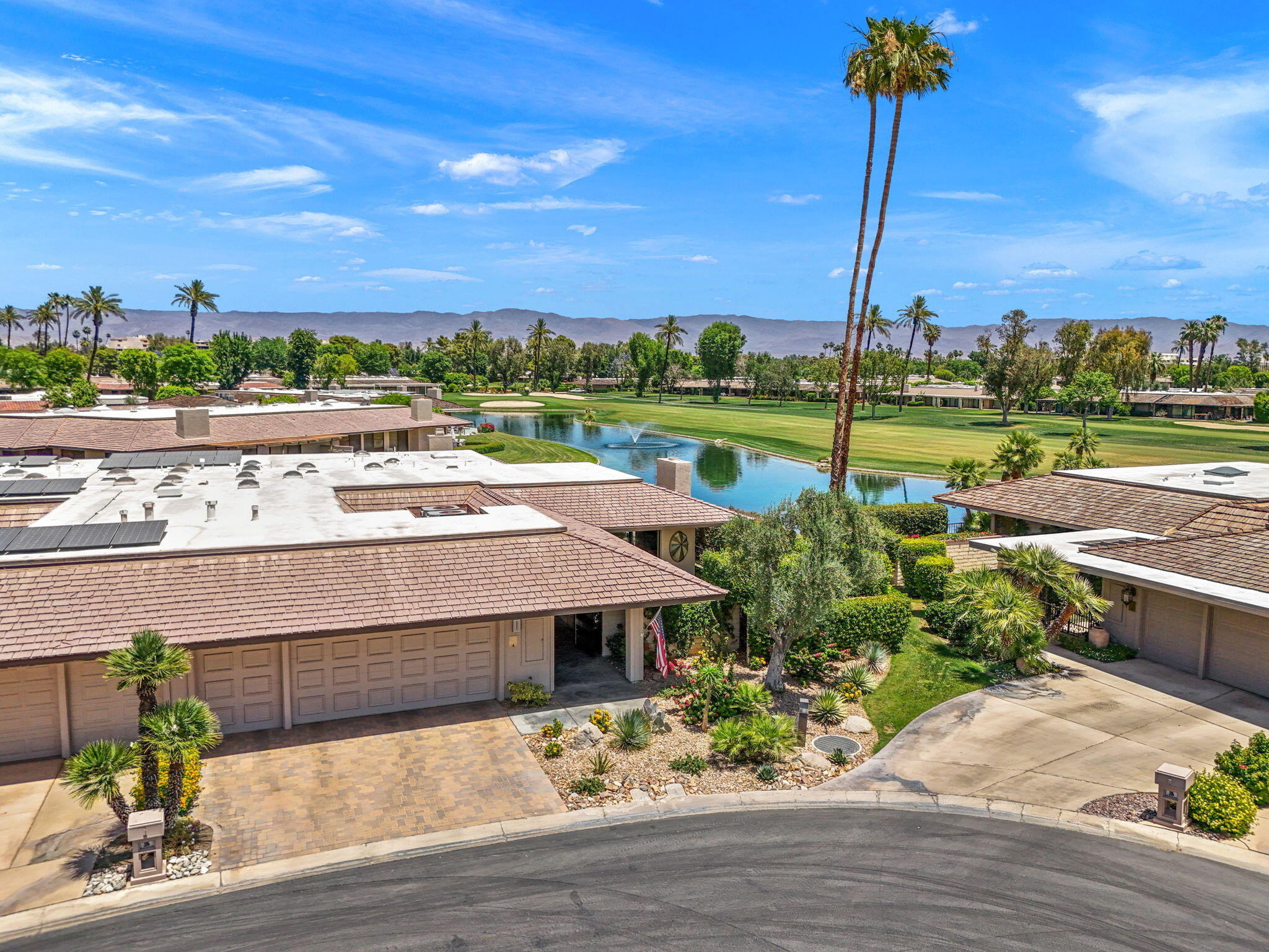 4 Barnard Court Rancho Mirage, CA 92270 - Photo 57 of 62 a view of a lake with a table and chairs