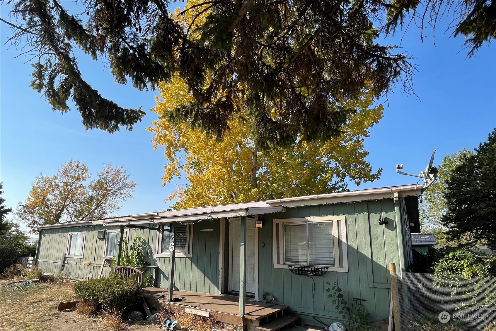 52 Engh Road, Unit 26 Omak, WA 98841 - Photo 1 of 29 a backyard of a house with plants and tree