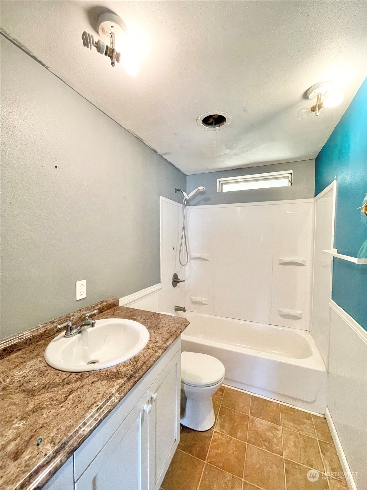 52 Engh Road, Unit 26 Omak, WA 98841 - Photo 15 of 29 a bathroom with a granite countertop sink toilet and shower