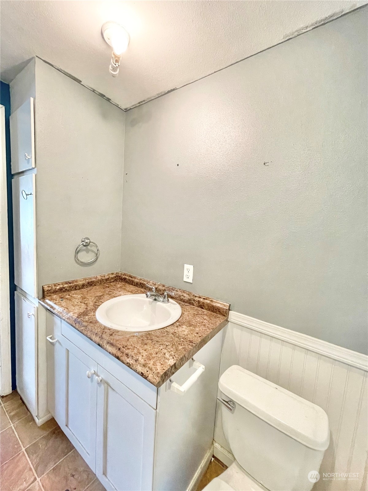 52 Engh Road, Unit 26 Omak, WA 98841 - Photo 16 of 29 a bathroom with a granite countertop toilet and a sink