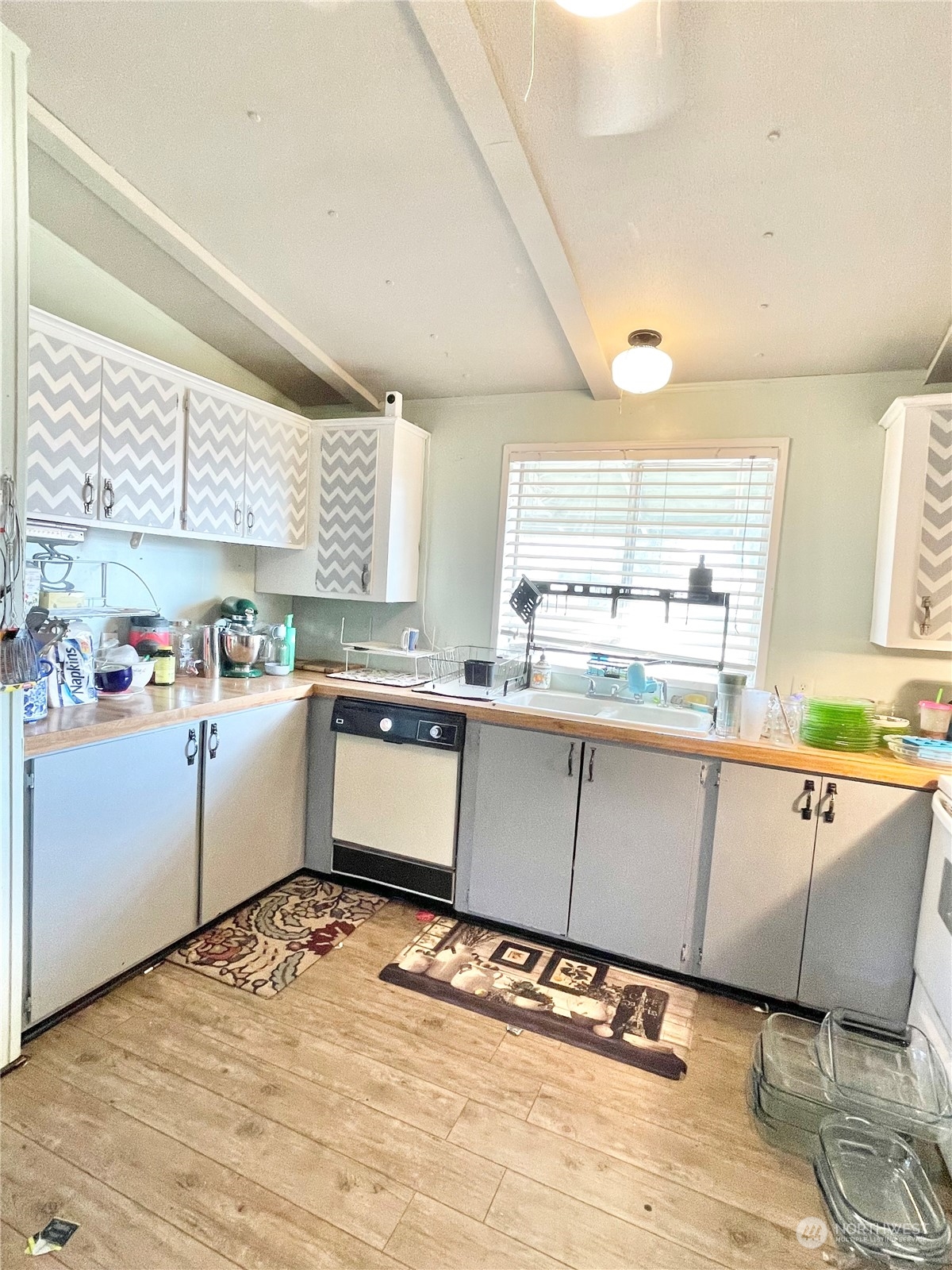 52 Engh Road, Unit 26 Omak, WA 98841 - Photo 10 of 29 a kitchen with stainless steel appliances kitchen island granite countertop a sink and cabinets