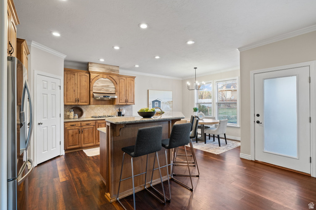 6208 West Bull River Road Highland, UT 84003 - Photo 22 of 90 Open-concept kitchen featuring wood-finish flooring, recessed lighting, and a kitchen island with seating