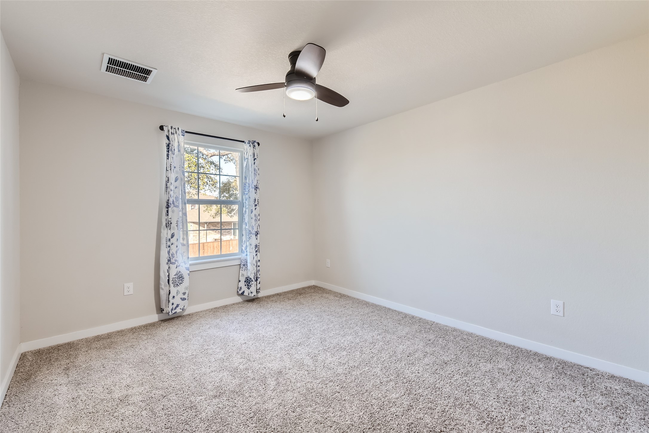 2212 Alamar Walk Leander, TX 78641 - Photo 17 of 29 an empty room with windows and fan