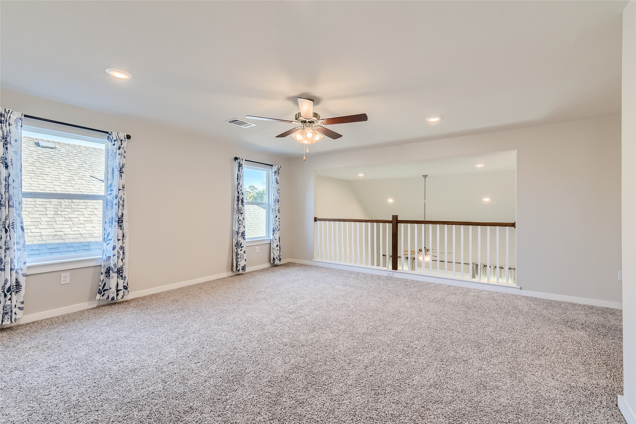 2212 Alamar Walk Leander, TX 78641 - Photo 21 of 29 an empty room with ceiling fan and windows