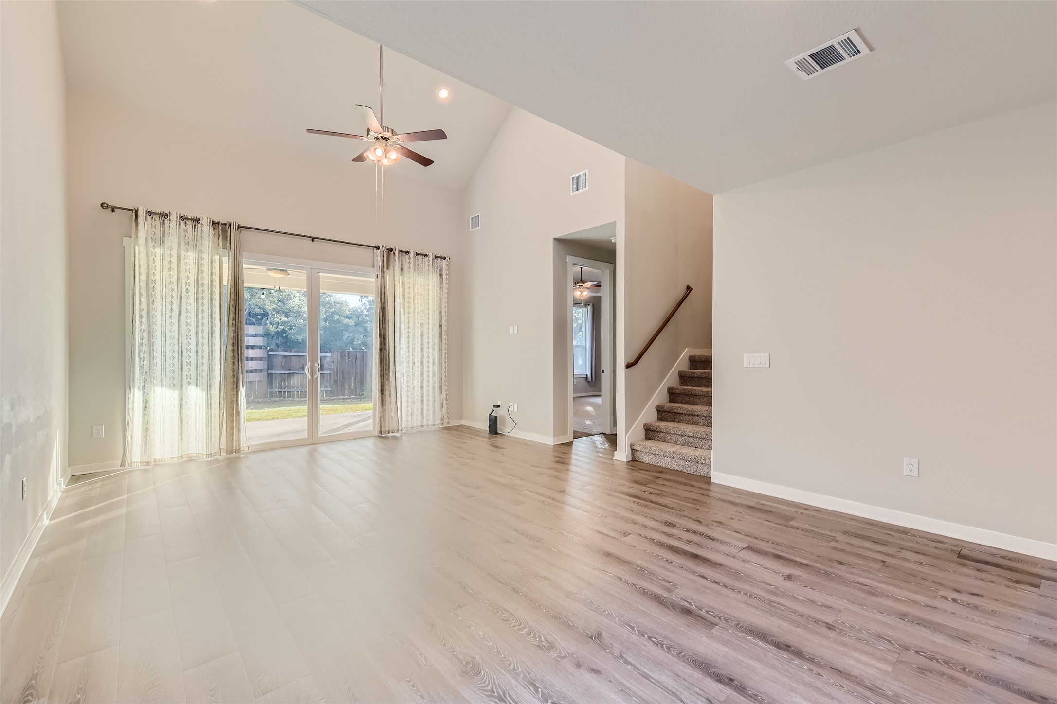2212 Alamar Walk Leander, TX 78641 - Photo 4 of 29 a view of an empty room with wooden floor and a window