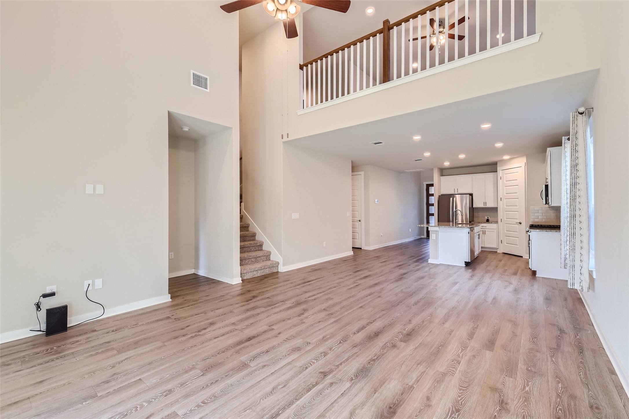 2212 Alamar Walk Leander, TX 78641 - Photo 5 of 29 a view of a living room with a wooden floor
