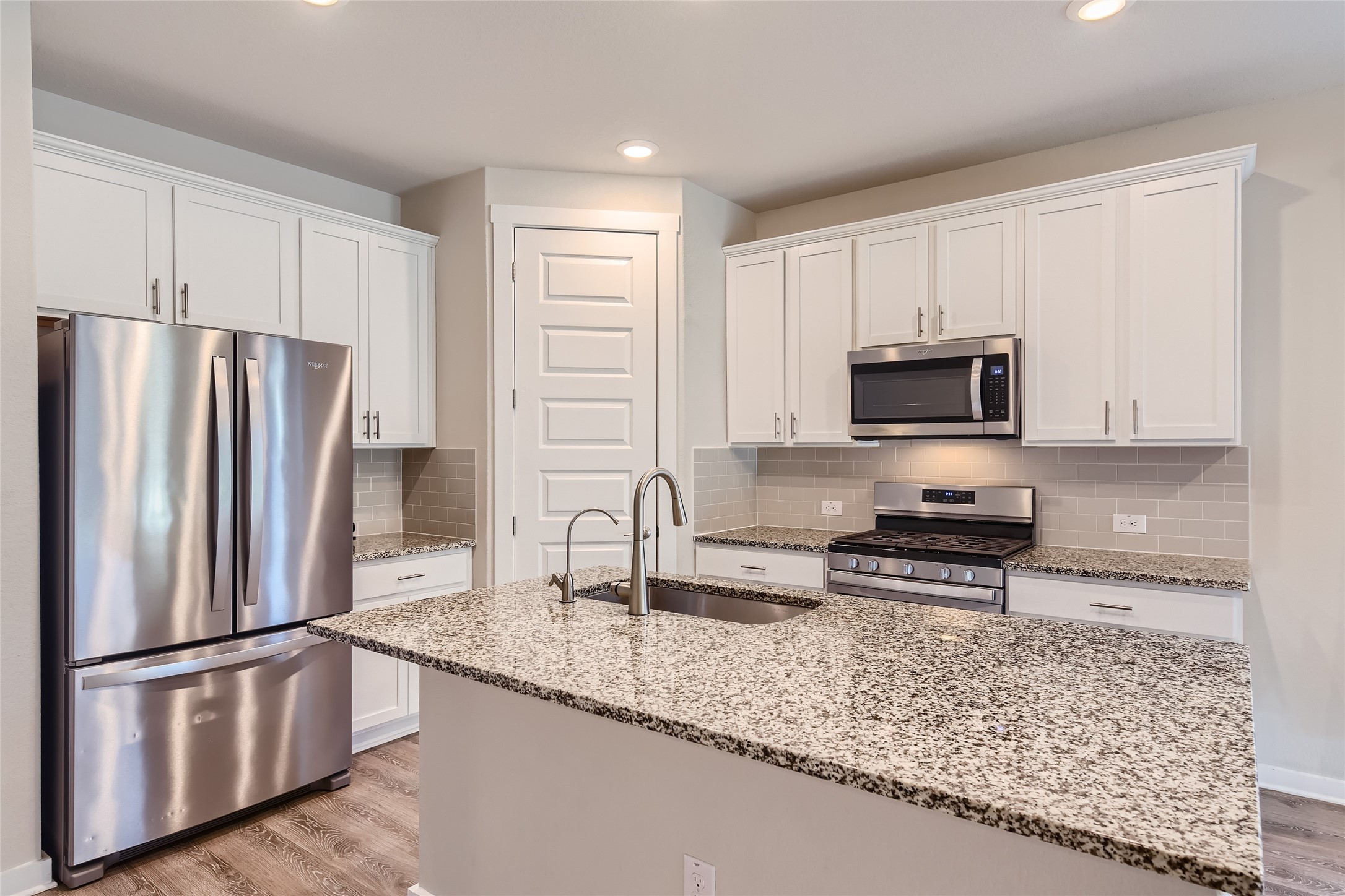 2212 Alamar Walk Leander, TX 78641 - Photo 8 of 29 a kitchen with stainless steel appliances granite countertop a refrigerator a stove a sink and white cabinets