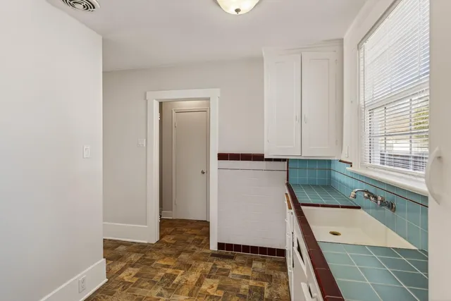 a room with washing machine and window
