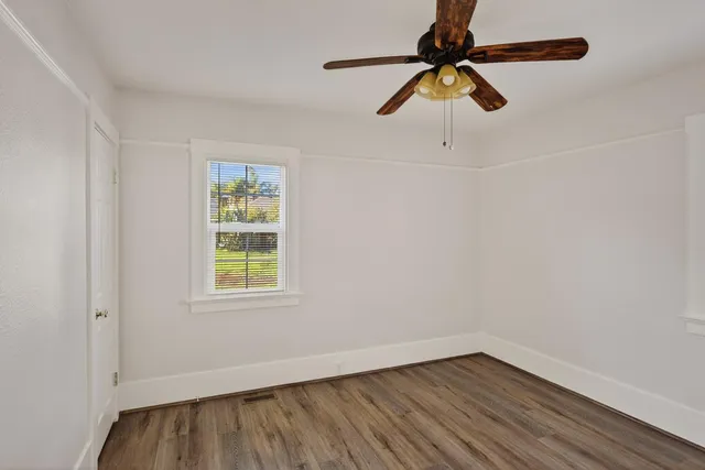 wooden floor in an empty room with a window