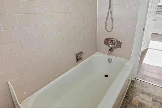 a bathroom with a tub and a shower