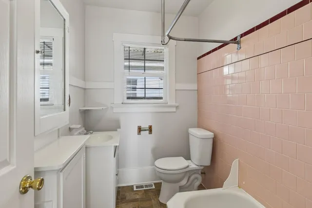a white toilet sitting next to a bathroom sink