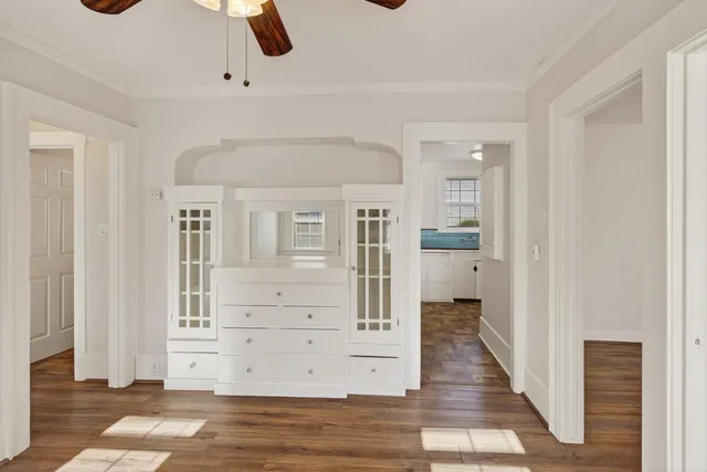 a view of a hallway with wooden floor and staircase