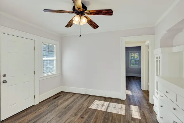 wooden floor in an empty room with a window
