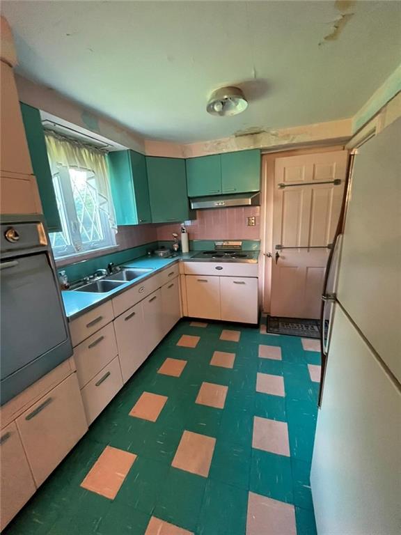 498 Highview Road Pittsburgh, PA 15228 - Photo 23 of 23 a kitchen with green cabinets stove and sink