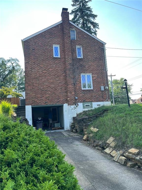 498 Highview Road Pittsburgh, PA 15228 - Photo 3 of 23 a brick house with a yard and a large tree