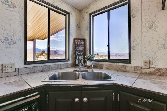 3727 Swallow Avenue Ridgecrest, CA 93555 - Photo 3 of 25 a kitchen with a sink a counter top space and a window