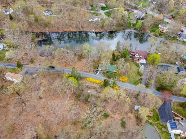 a view of a lake with a yard and potted plants