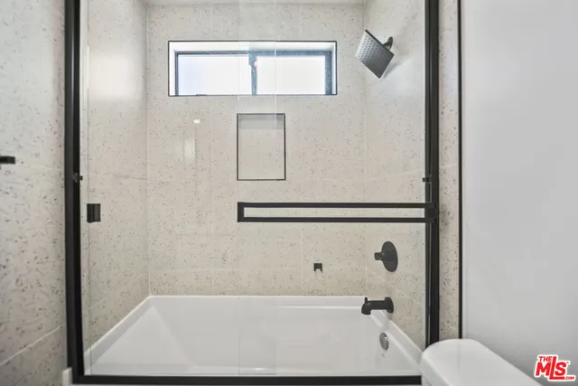 a bathroom with a bathtub and shower