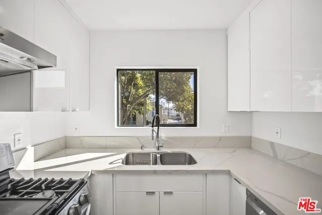 a kitchen with a sink stove and cabinets