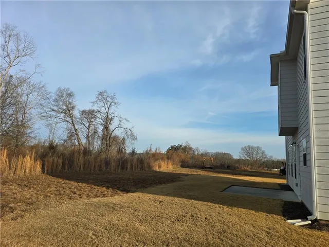 a house that has a tree in front of it