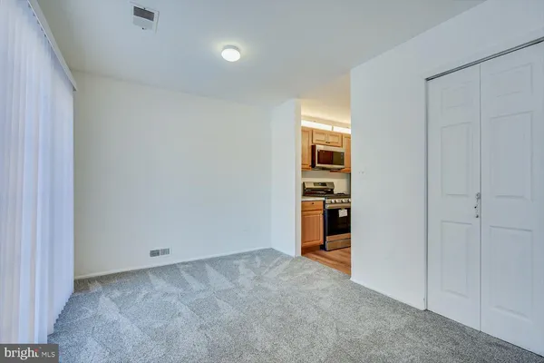 a view of a kitchen with a sink and a refrigerator