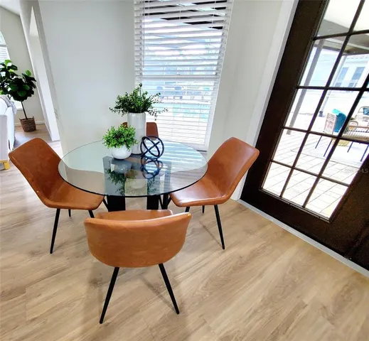 a view of a dining room with furniture and wooden floor