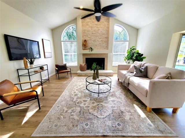 a living room with furniture a fireplace and a flat screen tv