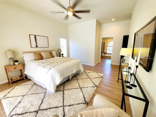 a bedroom with a bed and wooden floor