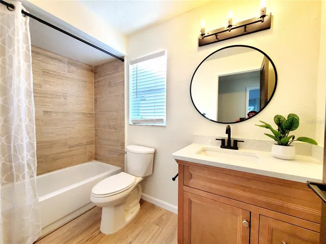 a view of white cabinets and a wooden floor