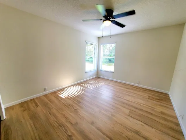 a view of a kitchen with wooden floor and electronic appliances