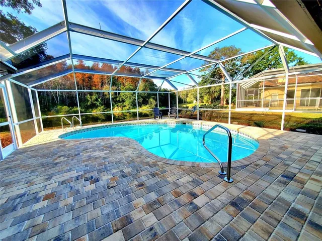 a view of a backyard with sitting area